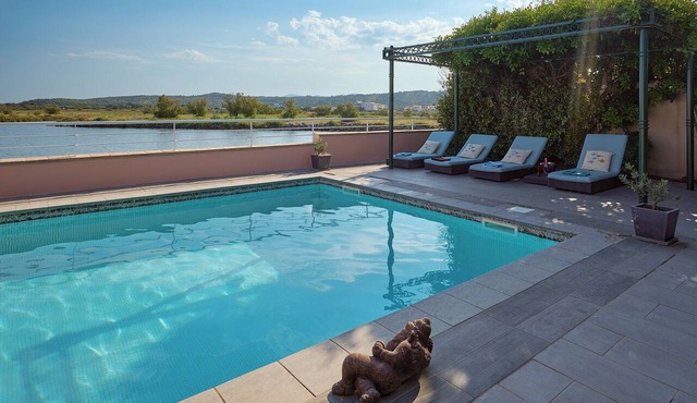 Pink House Vacation Rental overlooking a lake, the Mediterranean Sea, and Mount Canigou