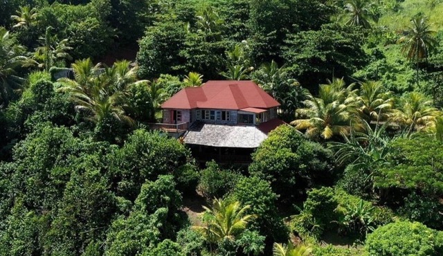 Private wooden villa with stunning ocean views, in an enchanting garden setting.