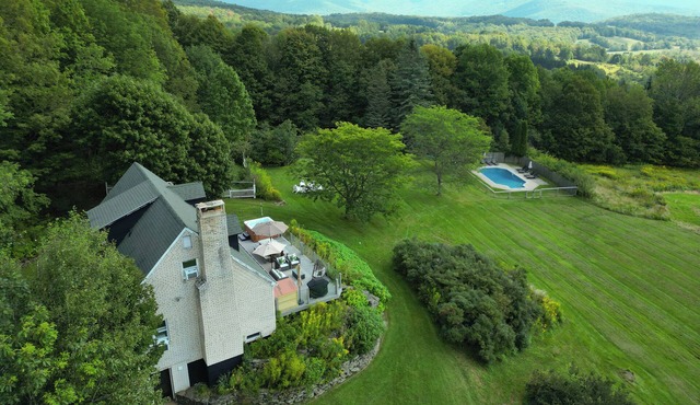 Private Contemporary Cottage with heated pool, hot tub and wide mountain views.