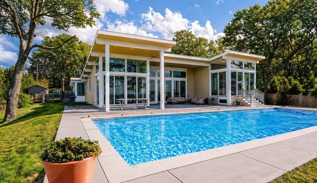 Quiet waterfront retreat in Hampton Bays featuring a private heated pool,.