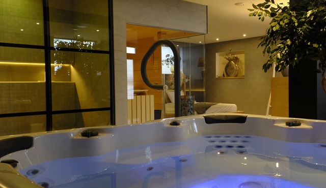 Relax in Wellness Room with Sauna and Spa Bath and luxurious outdoor seating.