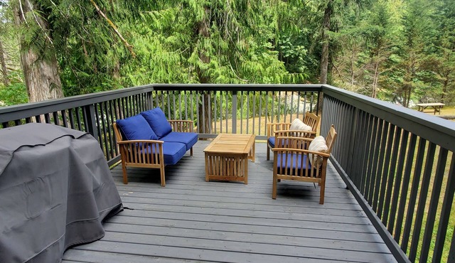 Riverfront cottage with stairs to the river, firepit, and forested retreat.
