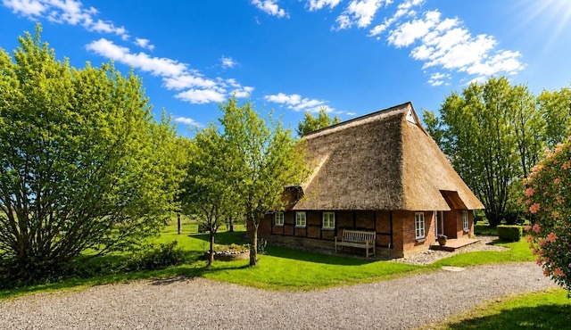 Romantic cottage under thatch surrounded by nature