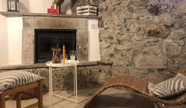 Rustic apartment with beams and stone.