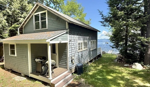 Rustic shorefront cottage with a small sandy beach