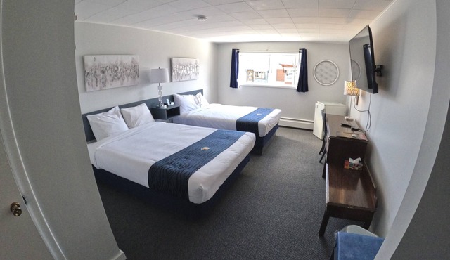 Simple room with 2 queen beds, full bathroom.