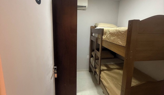 Single room with bunk bed and shared bathroom.