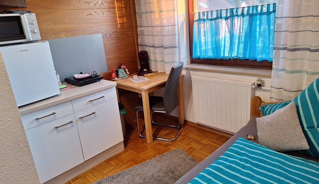 Single room with private bathroom and kitchenette.