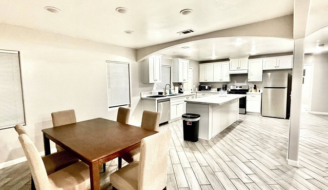 Spacious 4-bedroom house in charming Bakersfield with AC. 4 queen & 3 twin beds.