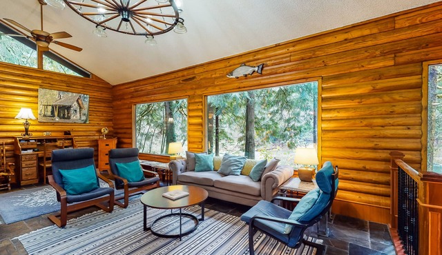 Spacious riverfront lodge with beach access, private hot tub & forest views