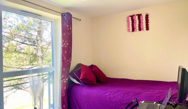 Spacious room with study table next to university