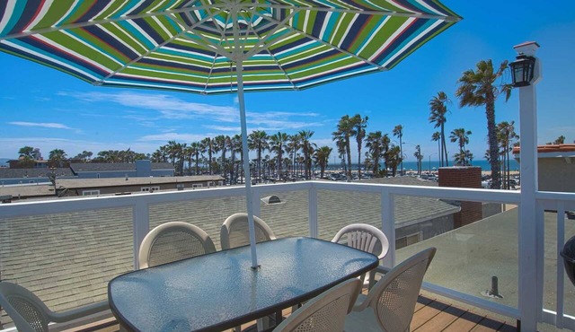 Spacious upper rear unit in an oceanfront triplex just steps from the Balboa Pier fun!
