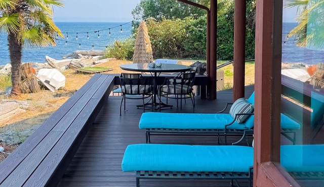 Spacious waterfront retreat with inviting deck, fireplace & games