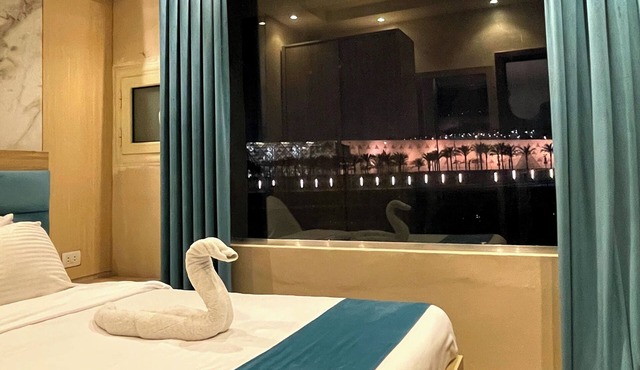 "Stay in Luxury: Hotel Room with Stunning Grand Egyptian Museum View"