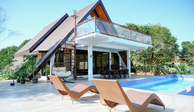 Step into an A-Frame home, where white tropical design meets ultimate comfort.