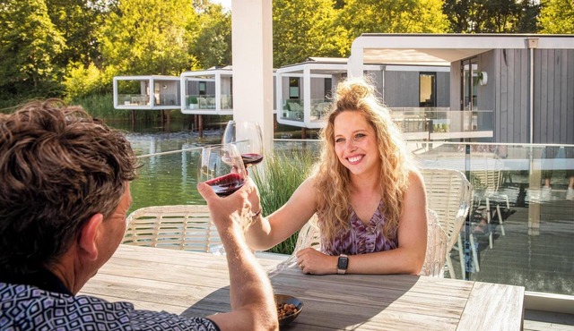 Stylish water cube for 5 guests with modern interior walk in shower and large terrace floating above the water.