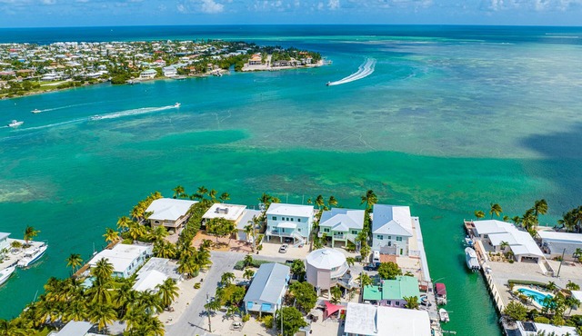 Sun-splashed dog-friendly home near water with heated pool, great deck, patio