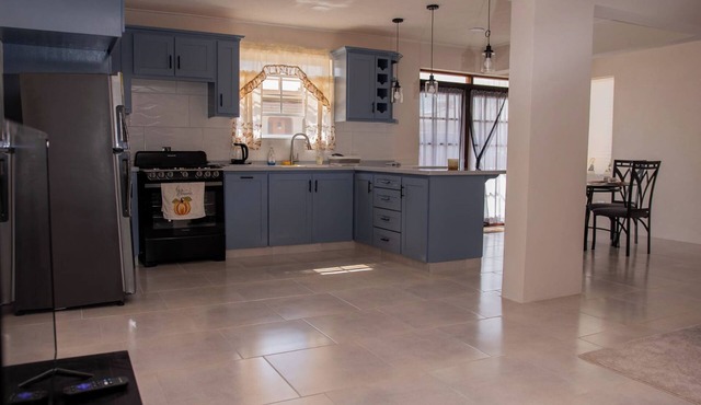 The apartment features an open plan living and dining area, and a spacious and modern kitchen.