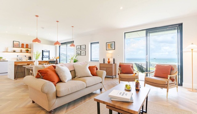 The Lighthouse is an end of terrace four bedroomed seafront retreat with a hot tub and incredible vi