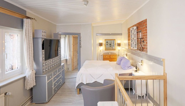 The open plan maisonette apartment extends over two floors in the back house