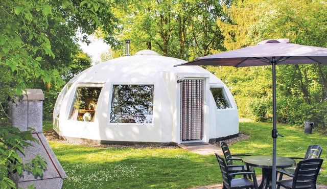 These detached bungalows with domed roofs are scattered in a wooded resort.