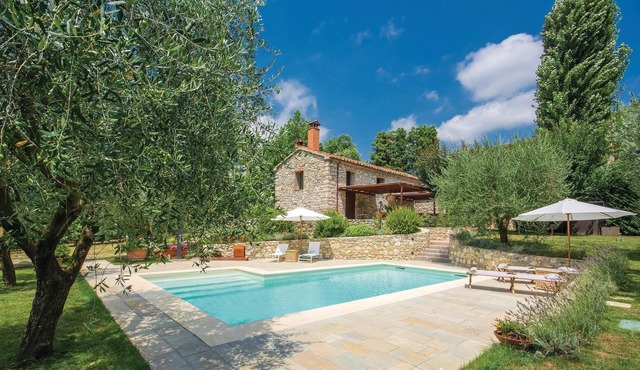 This characteristic vacation home, surrounded by a large, well-kept fenced garden, is located in the