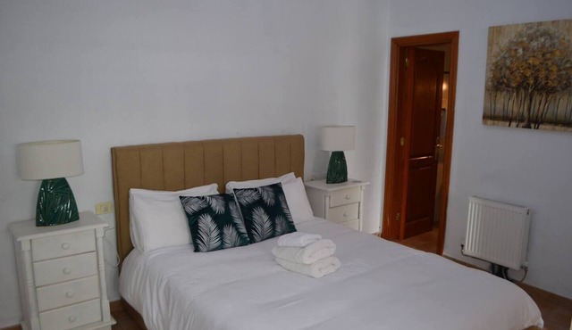 This is a double room with a double bed. It has an en-suite bathroom. The window in the room looks out into the hallway.