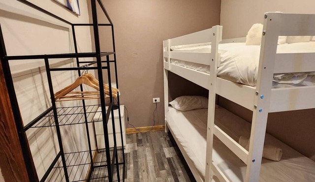 This room is a bunk room with two single bunk beds. The bathroom and showers are shared with the two other bunk rooms . The room has a great view of the village square.