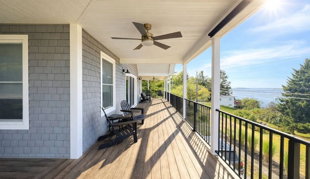 This spacious home offers a FANTASTIC covered porch, perfect to spend your days gazing at the ocean!