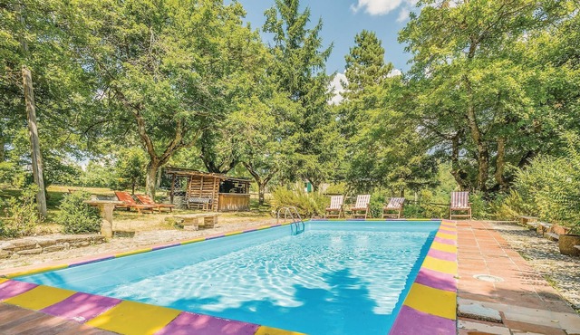 This vacation home, a former farmhouse, is surrounded by lush woods and is located on a 20-hectare p