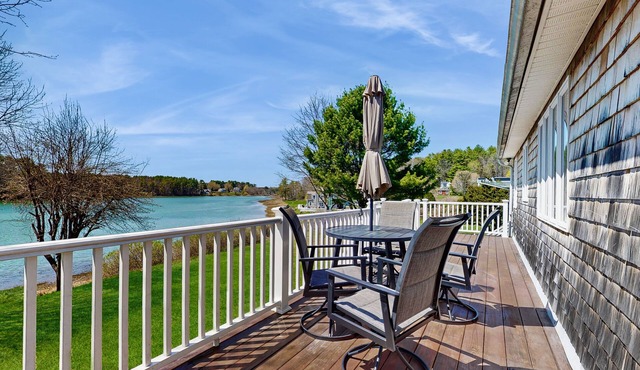 Tranquil waterfront home with stunning views, a spacious deck, and a BBQ grill