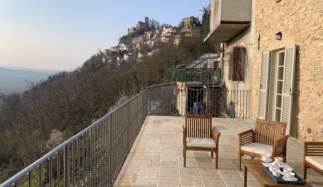 Two imposing houses set round an enclosed courtyard in ancient hill-top village