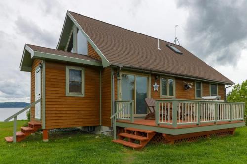 Two lakefront dog-friendly cabins on four acres with porches, dock, & lake views