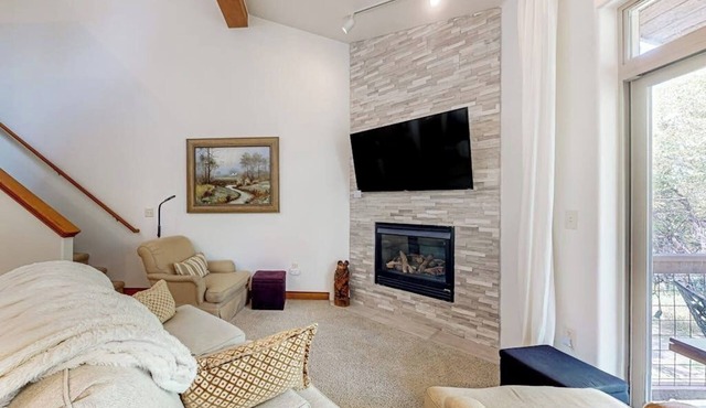 Two-story, riverfront condo with balcony & fireplace - close to everything