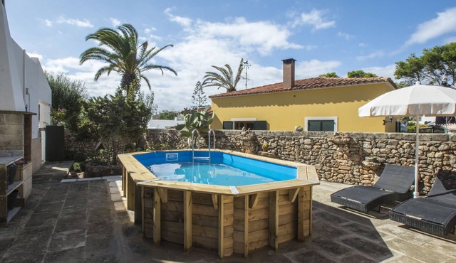 Typical Menorcan house steps from the beach. Pool, garden, barbecue and fireplace