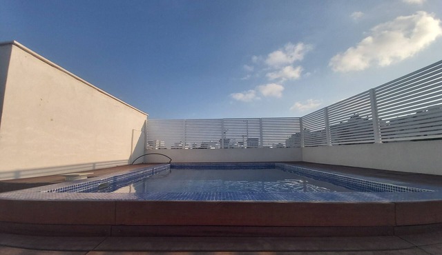 Very beautiful penthouse with a hot swimming pool under blue skies .