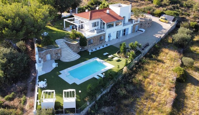 Villa surrounded by greenery with sea view and swimming pool