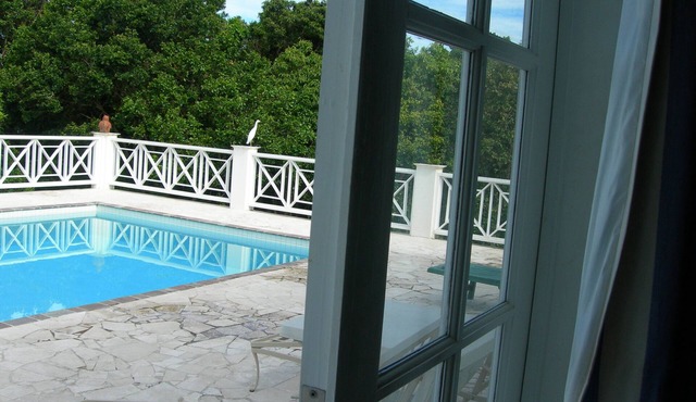 Villa with large pool, screened terrace overlooking Caribbean.