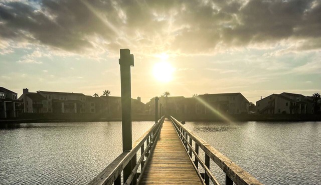Waterfront condo with bay view, outdoor pool, tennis, dock, balcony, W/D, & AC