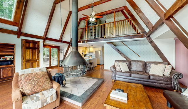 Waterfront home with wraparound deck, floating fireplace, deck, & firepit