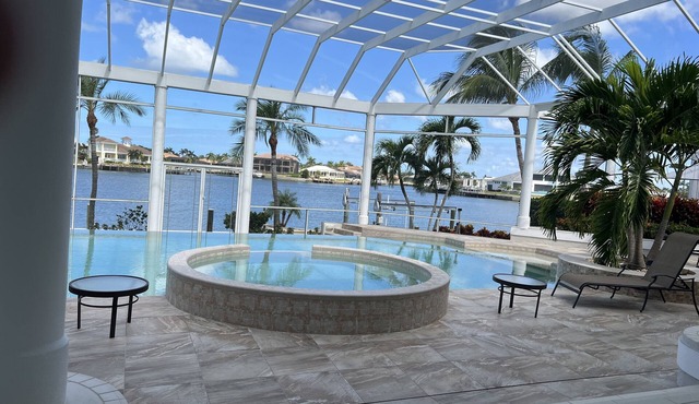 Waterfront home on Marco Island, large pool, & dock. Sleeps 18, many amenities.