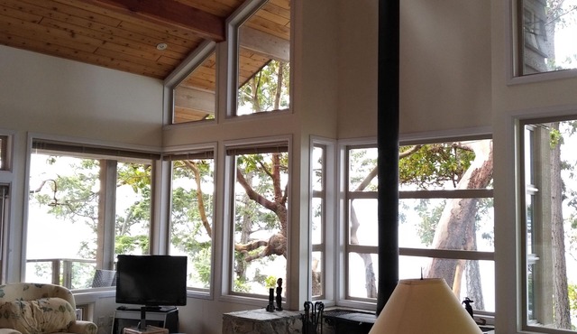 Waterfront home with stunning views, surrounded by nature.