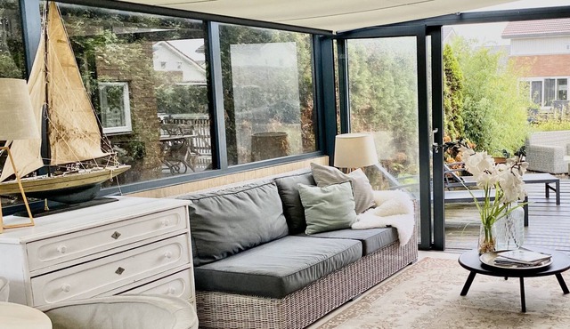 Waterfront home with fine sunroom and fireplace